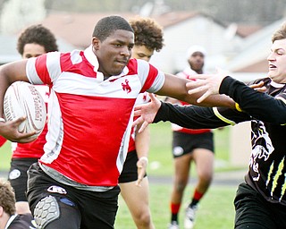 William D. Lewis the vindicator Chaney's JR Tellington(19) eludes a Massilon defender during 4-18-19 action at Chaney.