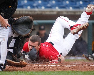 YSU's Lucas Nasonti slides safely into home before NKU's Collin Hohman gets a chance to tag him during their game at Eastwood Field on Friday. EMILY MATTHEWS | THE VINDICATOR