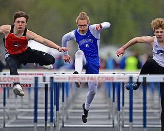 AUSTINTOWN, OHIO - APRIL 20, 2019: (LtoR) Springfield's Beau Brungard, Western Reserve's Luke Kilbert and Jackson Milton's Ryan Staton clear hurdles during the boys 110 meter hurdles during the Mahoning County Track & Field Championship Meet at Austintown Fitch High School. DAVID DERMER | THE VINDICATOR