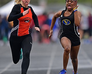 AUSTINTOWN, OHIO - APRIL 20, 2019: Springfield's Mary Grace Mason, left, and Valley Christian's Kennedy Tucker run to the finish line during the girls 100 meter dash during the Mahoning County Track & Field Championship Meet at Austintown Fitch High School. DAVID DERMER | THE VINDICATOR