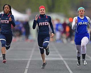 AUSTINTOWN, OHIO - APRIL 20, 2019: (LtoR) Fitch's Alena Williams and Logan Franczkowski and Poland's Mia Musolino run to the finish line during the girls 100 meter dash during the Mahoning County Track & Field Championship Meet at Austintown Fitch High School. DAVID DERMER | THE VINDICATOR