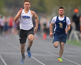 AUSTINTOWN, OHIO - APRIL 20, 2019: Jackson Milton's Sean Lengyel runs to the finish line ahead of Lowellville's Vinny Layko during the boys 100 meter dash during the Mahoning County Track & Field Championship Meet at Austintown Fitch High School. DAVID DERMER | THE VINDICATOR