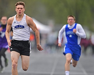 AUSTINTOWN, OHIO - APRIL 20, 2019: Jackson Milton's Dylan Gibbs runs to the finish line ahead of Western Reserve's Russell Adair during the boys 100 meter dash during the Mahoning County Track & Field Championship Meet at Austintown Fitch High School. DAVID DERMER | THE VINDICATOR