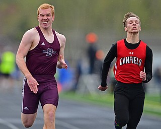 AUSTINTOWN, OHIO - APRIL 20, 2019: Boardman's Zach Hillard and Canfield's David Schmidt run to the finish line during the boys 100 meter dash during the Mahoning County Track & Field Championship Meet at Austintown Fitch High School. DAVID DERMER | THE VINDICATOR