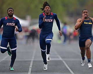 AUSTINTOWN, OHIO - APRIL 20, 2019: (LtoR) Fitch's Ralph Fitzgerald and Isiah Tarver and East's Giovanni Washington run to the finish line during the boys 100 meter dash during the Mahoning County Track & Field Championship Meet at Austintown Fitch High School. DAVID DERMER | THE VINDICATOR