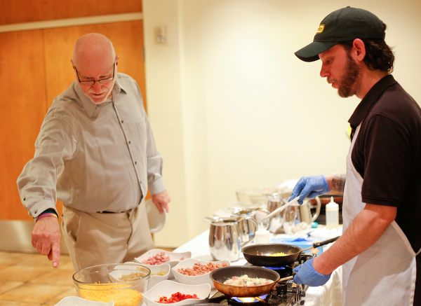Zeke Pedrick, right, with Kravitz Deli, prepares an omelette for Ed Medved, of Warren, at the annual Easter Brunch at Fellows Riverside Gardens on Sunday. EMILY MATTHEWS | THE VINDICATOR