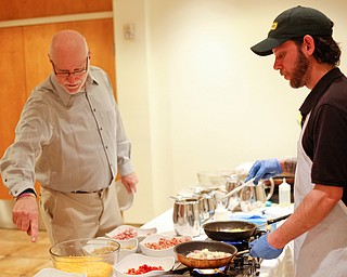 Zeke Pedrick, right, with Kravitz Deli, prepares an omelette for Ed Medved, of Warren, at the annual Easter Brunch at Fellows Riverside Gardens on Sunday. EMILY MATTHEWS | THE VINDICATOR