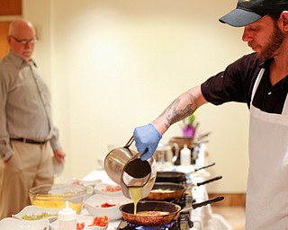 Zeke Pedrick, right, with Kravitz Deli, prepares an omelette for Ed Medved, of Warren, at the annual Easter Brunch at Fellows Riverside Gardens on Sunday. EMILY MATTHEWS | THE VINDICATOR