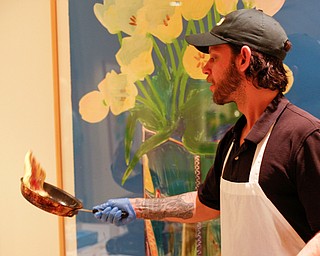 Zeke Pedrick, with Kravitz Deli, flips an omelette at the annual Easter Brunch at Fellows Riverside Gardens on Sunday. EMILY MATTHEWS | THE VINDICATOR