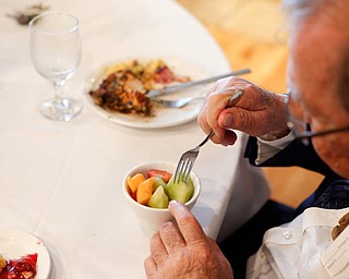 Doug Neuman, of Niles, eats fruit at the annual Easter Brunch at Fellows Riverside Gardens on Sunday. EMILY MATTHEWS | THE VINDICATOR