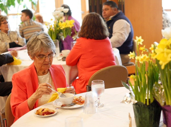 Jane Porter, of Niles, eats at the annual Easter Brunch at Fellows Riverside Gardens on Sunday. Her daughter, Billie Neuman, said this is Porter's 95th Easter. EMILY MATTHEWS | THE VINDICATOR