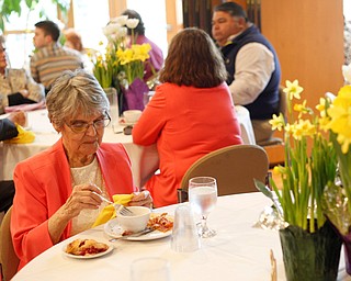 Jane Porter, of Niles, eats at the annual Easter Brunch at Fellows Riverside Gardens on Sunday. Her daughter, Billie Neuman, said this is Porter's 95th Easter. EMILY MATTHEWS | THE VINDICATOR