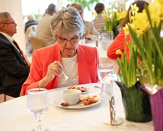 Jane Porter, of Niles, eats at the annual Easter Brunch at Fellows Riverside Gardens on Sunday. Her daughter, Billie Neuman, said this is Porter's 95th Easter. EMILY MATTHEWS | THE VINDICATOR