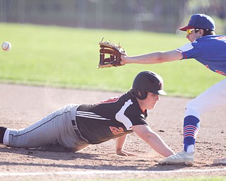 Chris Thompson (20)  of Springfield High School slides safely back to first underneath the tag by Dan Windham (3) of Western Reserve High School during Monday afternoon's game. Springfield won 3-1.