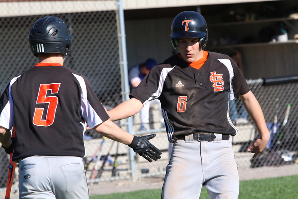 Springfield’s Jarret Orbin (8) celebrates with teammate John Slike (5) after scoring the the first run of the game  during Monday afternoons game against Western Reserve at Springfield High School.  Dustin Livesay  |  The Vindicator  4/22/19  Springfield Local