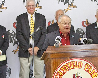George Roman III speaks at a press conference Wednesday morning at the Canfield Fairgrounds, at which the final pieces of the entertainment schedule were announced. Standing behind Roman, who is in charge of grandstand attractions, are members of the Canfield Fair Board of Directors.
