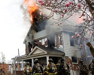 Firefighters work to put out a house fire on Wilson Avenue on Wednesday afternoon. EMILY MATTHEWS | THE VINDICATOR