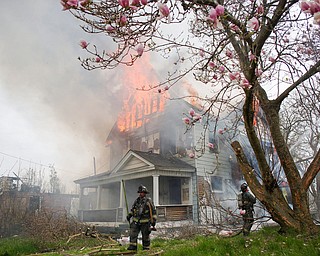 Firefighters work to put out a house fire on Wilson Avenue on Wednesday afternoon. EMILY MATTHEWS | THE VINDICATOR