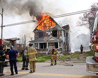 Firefighters work to put out a house fire on Wilson Avenue on Wednesday afternoon. EMILY MATTHEWS | THE VINDICATOR