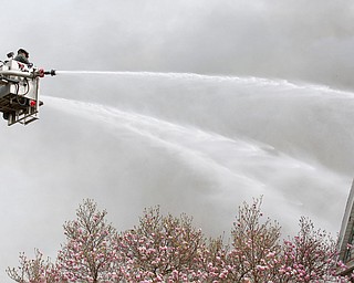 Firefighters work to put out a house fire on Wilson Avenue on Wednesday afternoon. EMILY MATTHEWS | THE VINDICATOR