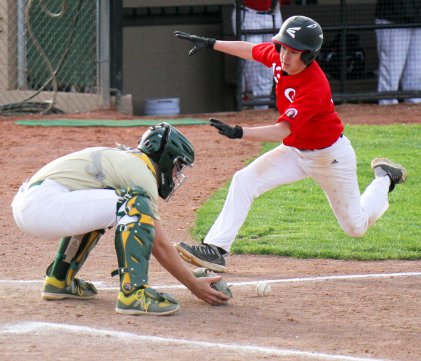 William D. Lewis The Vindicator  Girard's Jayden Maggs(13) scores as Ursuline catcher Jake Freisen(2) waits for the ball during 4-24-19 game at Cene.