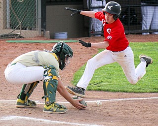 William D. Lewis The Vindicator  Girard's Jayden Maggs(13) scores as Ursuline catcher Jake Freisen(2) waits for the ball during 4-24-19 game at Cene.