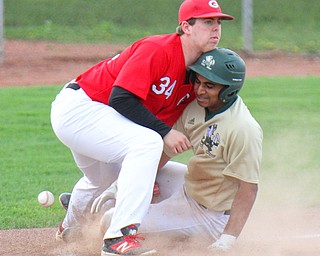 Girard third baseman Matt Miles (34) loses control of the ball as Ursuline's Dante Walker (27) is safe at third during Wednesday's  game at Cene park