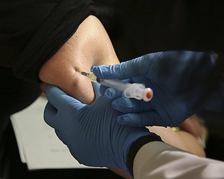 A woman receives a measles, mumps and rubella vaccine at the Rockland County Health Department in Pomona, N.Y. Measles cases in the U.S. this year have climbed to the highest level in 25 years, according to preliminary figures, a resurgence attributed largely to misinformation about vaccines. 