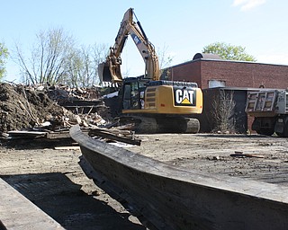 Demolition of the former Garfield Elementary School on Third Street in Niles as it looked on Wednesday. An employee from the Trumbull County Engineer's office stands at left near several steel beams to be sold for scrap. The former gymnasium at right will be the last part of the school to be removed.