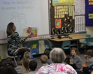 Neighbors | Abby Slanker.Hilltop Elementary School first-grade teacher Mary Kozlowski read “How to Babysit a Grandma and a Grandpa” to her class and their grandparents during the school’s annual Grandparents Day on March 14.