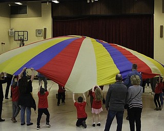 Neighbors | Abby Slanker.Hilltop Elementary School first-grade students and their grandparents played games with a giant parachute while visiting physical education teacher Linda Magyar in the gym during the school’s annual Grandparents Day on March 14.