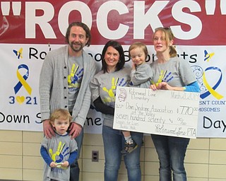 Neighbors | Jessica Harker.Doug (left) and Connor Levendosky (front) posed with kindergarten teacher Candace Wright, Liam Levendosky and Rebecca Levendosky (right) after Wright presented the Levendoskys with a $770 check donated by the school for their Buddy Walk later this year.