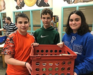 Neighbors | Submitted.Poland seventh-graders, from left, Kyle Varkonda, Michael Fitzpatrick and Jett Slaina, helped collect donated books for the Caring Club's book drive.