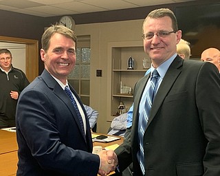Neighbors | Submitted.The Boardman Local School Board hired Marco Marinucci as the district’s next athletic director. Board President Jeff Barone (left) is pictured congratulating Marinucci on his new position.
