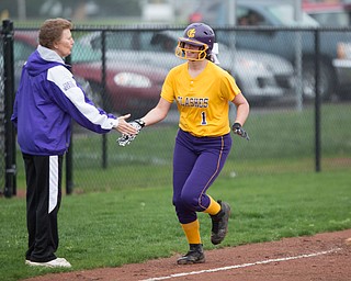 Champion's Emma Gumont high-fives Head Coach Cheryl Weaver after hitting a home run during their game against Crestview at Champion High School on Thursday. Champion won 10-0 with a mercy rule in the fifth inning. EMILY MATTHEWS | THE VINDICATOR