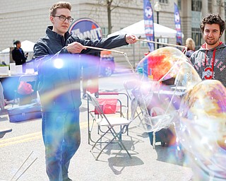 Nathan Williams, left, a sophomore studying biochemistry at Youngstown State University, makes big bubbles while Joseph Agati, a junior studying environmental science and geography at YSU, watches during Federal Frenzy on Saturday. EMILY MATTHEWS | THE VINDICATOR