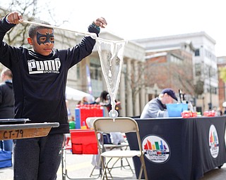 Christopher McDuffie, 9, of Youngstown, tries to form big bubbles at the YSU's chapter of the American Chemical Society's table at Federal Frenzy on Saturday. EMILY MATTHEWS | THE VINDICATOR