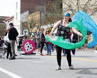 Kelsi Owen, of Niles and with the hula hoop performance troupe Infini-Tribe, dances with silk fans at Federal Frenzy on Saturday. EMILY MATTHEWS | THE VINDICATOR