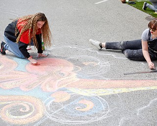 Anne Gulfo, left, a sophomore studying graphic design at Youngstown State University, and Rachel Hritz, a freshman studying art education and painting at YSU, draw an octopus with chalk at Federal Frenzy on Saturday. EMILY MATTHEWS | THE VINDICATOR