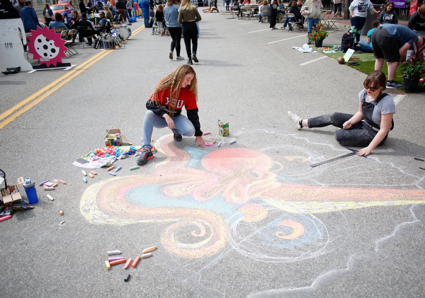 Anne Gulfo, left, a sophomore studying graphic design at Youngstown State University, and Rachel Hritz, a freshman studying art education and painting at YSU, draw an octopus with chalk at Federal Frenzy on Saturday. EMILY MATTHEWS | THE VINDICATOR