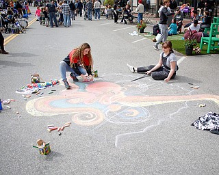 Anne Gulfo, left, a sophomore studying graphic design at Youngstown State University, and Rachel Hritz, a freshman studying art education and painting at YSU, draw an octopus with chalk at Federal Frenzy on Saturday. EMILY MATTHEWS | THE VINDICATOR