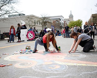 Anne Gulfo, left, a sophomore studying graphic design at Youngstown State University, and Rachel Hritz, a freshman studying art education and painting at YSU, draw an octopus with chalk at Federal Frenzy on Saturday. EMILY MATTHEWS | THE VINDICATOR