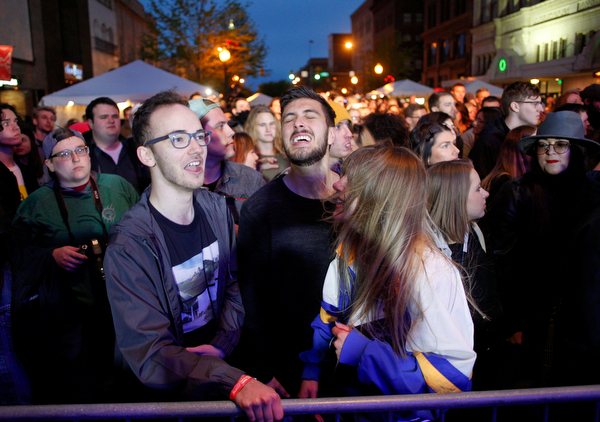 From left, Cole Stanich, Drew Wagner, and Alison Green, all of Boardman, dance and sing as they watch and listen to Spirit of the Bear perform at Penpro Main Stage during Federal Frezny on Saturday night. EMILY MATTHEWS | THE VINDICATOR