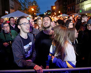 From left, Cole Stanich, Drew Wagner, and Alison Green, all of Boardman, dance and sing as they watch and listen to Spirit of the Bear perform at Penpro Main Stage during Federal Frezny on Saturday night. EMILY MATTHEWS | THE VINDICATOR