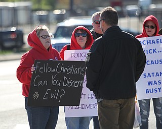 Tara Vybiral (left) and Melissa Garvin (middle) of Pittsburgh express their concerns to people walking to the Covelli Center to attend the Mens Rally in the Valley that had Michael Vick as one of the speakers on this years program.  Dustin Livesay  |  The Vindicator  4/27/19  Covelli Center.