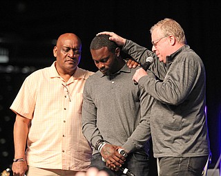 Pastors Gary Frost (left) and Jonatham Moore (right) pray for Michael Vick after he spoke to the crowd at the Mens Rally in the Valley on Saturday morning at the Covelli Center in downtown Youngstown.   Dustin Livesay  |  The Vindicator  4/27/19 Covelli Center