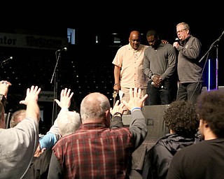 Pastors Gary Frost (left) and Jonatham Moore (right) pray for Michael Vick after he spoke to the crowd at the Mens Rally in the Valley on Saturday morning at the Covelli Center in downtown Youngstown.   Dustin Livesay  |  The Vindicator  4/27/19 Covelli Center