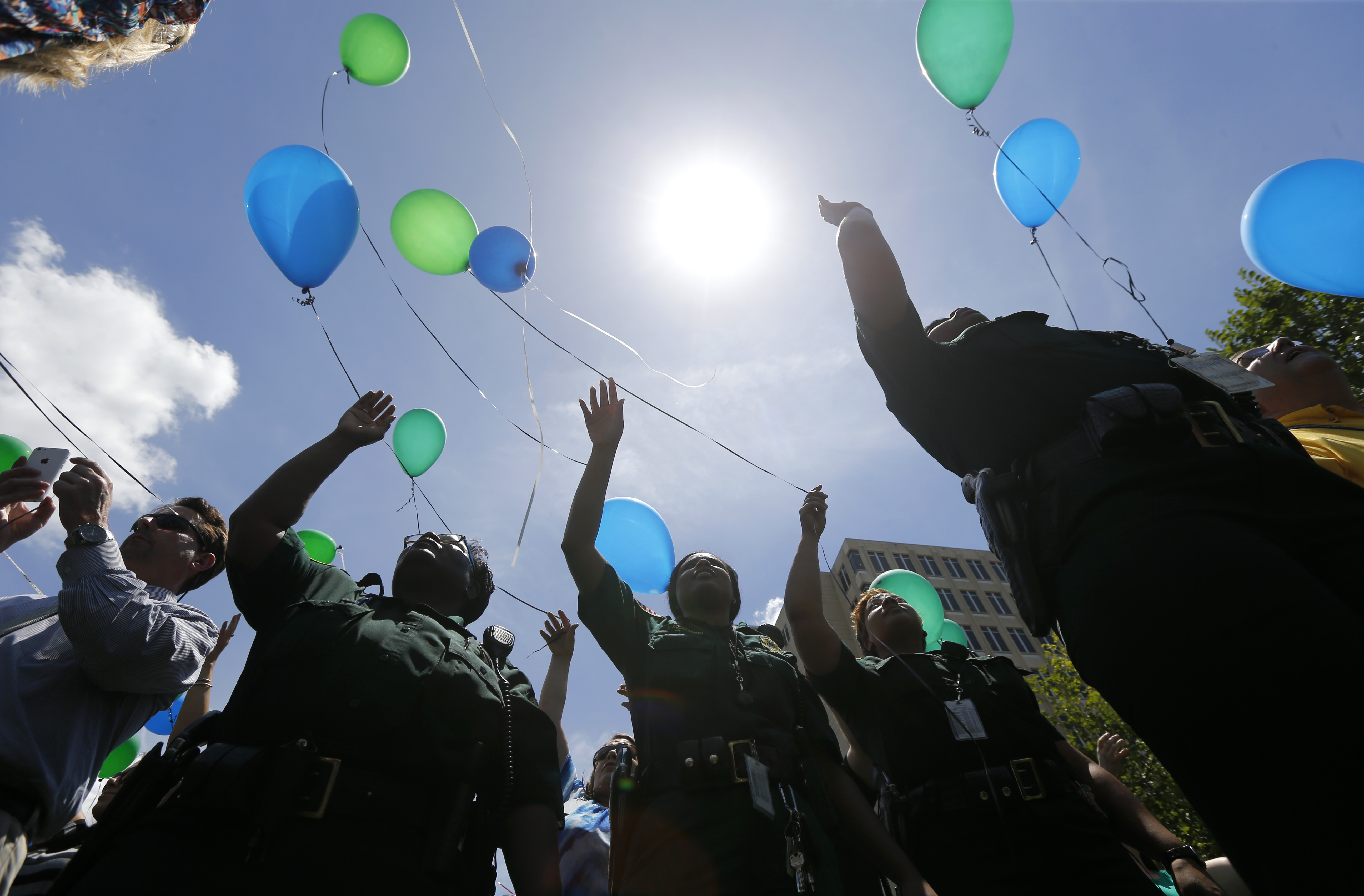 In this July 20, 2106 file photo, East Baton Rouge Sheriff's deputies release balloons at a noon vigil organized by municipal court workers in downtown Baton Rouge, La., in honor of slain and injured deputy sheriffs and police. Bills are pending in a growing number of states in 2019 to ban the feel-good tradition of releasing helium-filled balloons at events, since they have the unintended consequence of spoiling the environment and threatening wildlife.