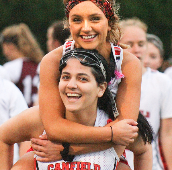 William D. Lewis the vindicator  Canfield's Mia Malvasi(27) carries Grace Ramun(10 on her shoulders afte their team defeated Boardman in 4-29-19 action at Canfield.