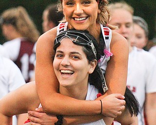 William D. Lewis the vindicator  Canfield's Mia Malvasi(27) carries Grace Ramun(10 on her shoulders afte their team defeated Boardman in 4-29-19 action at Canfield.